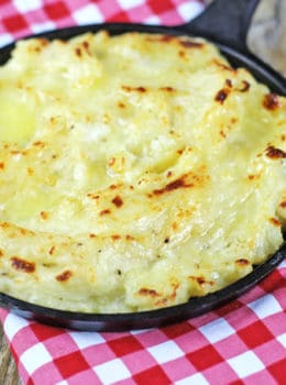 The richest mashed potatoes with five kinds of dairy! They are tangy, cheesy, rich and creamy with a deliciousy crisp crust out of the oven.