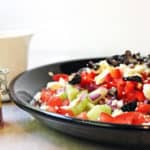A delicious Rainbow Greek Vegetable salad in a rainbow of colors. Fresh and healthy it is topped with salty rich feta and kalamata olives. Less than 200 calories a serving, eat the rainbow!