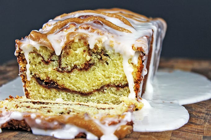 Tender, Rich Cinnamon Roll Pound Cake drenched in Cinnamon Swirl Icing. Easy to make, addicting to eat and perfect for your morning cup of coffee!