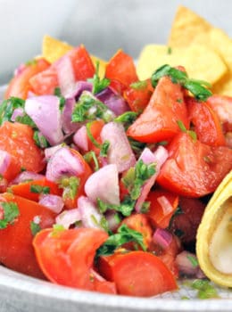 Pico de Gallo salad made with fresh tomatoes, red onions, jalapenos, cilantro and lime juice. You would expect it to be spicy, but the flavors work perfectly and this dish stands out as a delicious side to a great Mexican meal. Go ahead and add some cheese to your tacos because this salad has no fat!! You could eat the whole bowl completely guilt free!