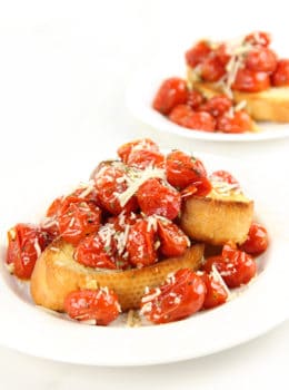 Hold on to those fleeting memories of summer with these amazing Roasted Garlic Tomatoes made in just 15 minutes and versatile enough to be an appetizer, part of a main course or a fantastic spread on a sandwich!