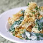 Your favorite Spinach and Artichoke Dip in a pasta bake with a Parmesan Buttery Cracker crust! Made with Mozzarella, Parmesan, cream cheese and sour cream with fresh spinach and artichoke hearts.