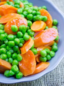 Classic Buttered Carrots and Peas made in just one bowl in a microwave and just five minutes using fresh carrots and frozen sweet green peas. A perfect bright side dish to your favorite meal.