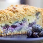 Blueberry Cream Cheese Coffee Cake with a tender center, creamy filling and a crunchy, buttery topping. A perfect mix of crumb coffee cake and cheesecake.