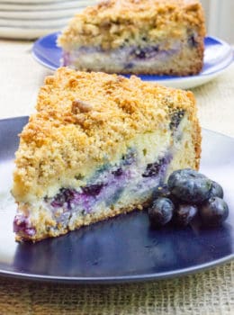 Blueberry Cream Cheese Coffee Cake with a tender center, creamy filling and a crunchy, buttery topping. A perfect mix of crumb coffee cake and cheesecake.