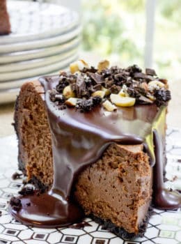 Rich Chocolate Hazelnut Cheesecake made with Chocmeister Milk Chocolatey Hazelnut Spread, a chocolate cookie crust and a thick, glossy chocolate ganache.