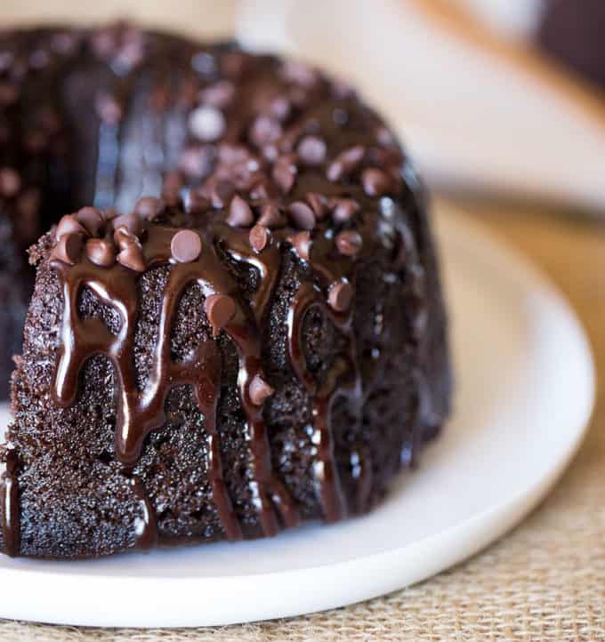 Triple Chocolate Bundt Cake with the richest chocolate cake made from scratch and covered in a dark chocolate ganache and extra chocolate chips.