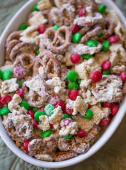 Christmas White Chocolate Trash Snack Mix with pretzels, cereal, peanuts and chocolate coated candies all tossed together with a generous coating of white chocolate.