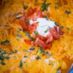 Slow Cooker Chicken Enchilada Dip takes just five minutes of prep with raw chicken, enchilada sauce and veggies topped with a bunch of deliciously melty cheddar cheese.