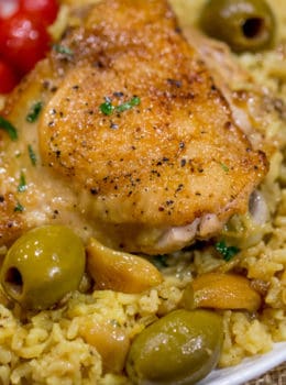 Spanish Olives Chicken and Rice made in a single cast iron skillet is a gorgeous meal made easy with delicious Spanish queen green olives, caramelized onions, garlic and saffron rice.