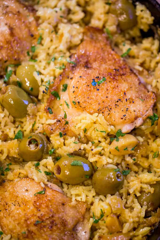 Spanish Olives Chicken and Rice made in a single cast iron skillet is a gorgeous meal made easy with delicious Spanish queen green olives, caramelized onions, garlic and saffron rice.