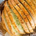 Sliced Garlic Bread Loaf made with a pre-sliced loaf of bread in just minutes and enough to feed a large crowd with no mess or slicing involved. In the oven in minutes.