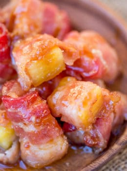 Spicy Sweet Bacon Wrapped Pineapple Bites caramelized with brown sugar and hot sauce make a perfect sticky, sweet, spicy, fruity bacon bite your guest will love in just minutes!