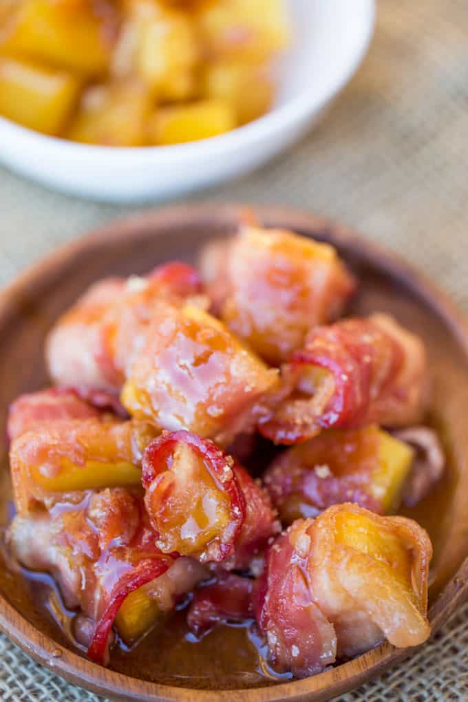 Spicy Sweet Bacon Wrapped Pineapple Bites caramelized with brown sugar and hot sauce make a perfect sticky, sweet, spicy, fruity bacon bite your guest will love in just minutes!