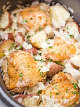 Slow Cooker Garlic Parmesan Chicken and Potatoes takes just a few minutes of prep and five ingredients. Crisp chicken thighs, buttery red potatoes and shaved Parmesan cheese make the perfect easy weeknight meal.