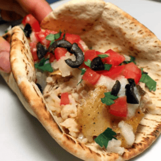 chicken and toppings in a pita