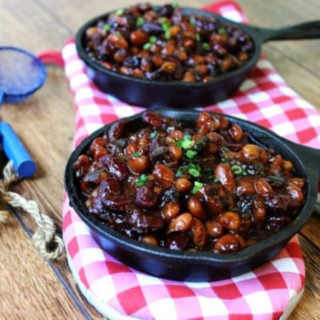 small cast iron with beans being served on a table