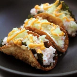 3 crunchy tacos on plate with sushi filling
