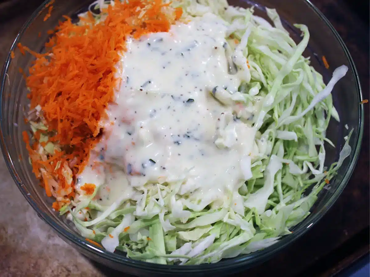 dressing poured over salad in a bowl
