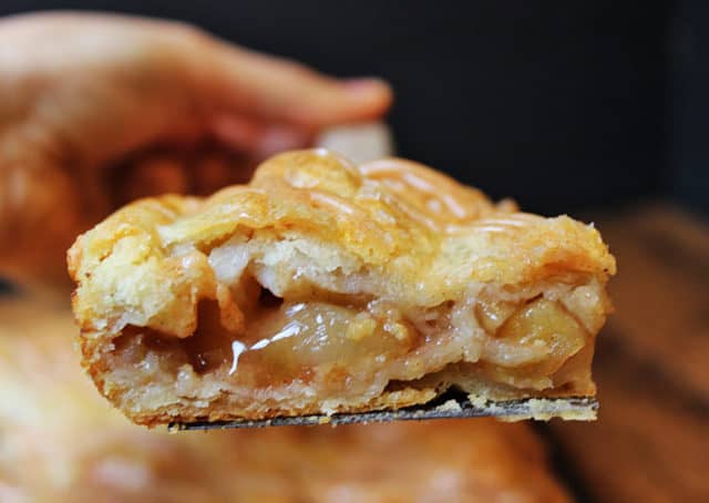 A flaky crust, tender apples, warm spices, it's a delicious handheld pie in slab form, which means you get more crust per bite! It is topped with all the flavors in the pie because it uses all the leftover spiced liquids from the apples!