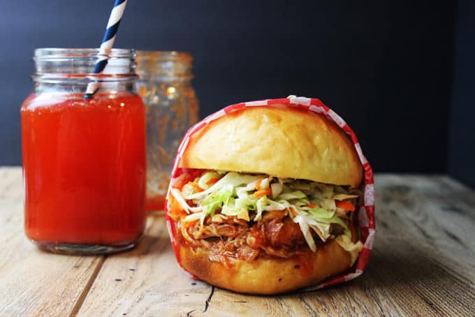 Sweet and Tangy Pulled BBQ Chicken Sandwich topped with Cole Slaw. A perfect meal for your 4th of July BBQ!