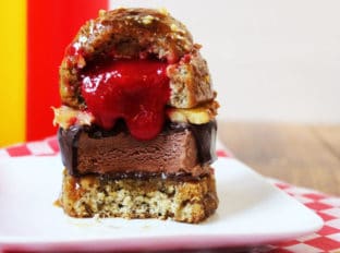 A showstopping dessert with all the flavors of a banana split in the shape of a burger. Strawberry sauce and white chocolate filled banana cake glazed with caramel sauce and topped with crushed peanuts filled with pineapple and a dark chocolate dipped ice cream bar. Your guest's mouths will drop open when they see the dessert and do it a second time when they break into it as see the strawberry sauce "ketchup" spill out.