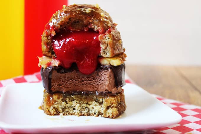 A showstopping dessert with all the flavors of a banana split in the shape of a burger. Strawberry sauce and white chocolate filled banana cake glazed with caramel sauce and topped with crushed peanuts filled with pineapple and a dark chocolate dipped ice cream bar. Your guest's mouths will drop open when they see the dessert and do it a second time when they break into it as see the strawberry sauce "ketchup" spill out.