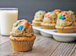 Chocolate Chip Peanut Butter Cupcakes topped with Monster Cream Cheese Cookie Dough Frosting! Full of M&Ms, peanut butter, brown sugar, oats and chocolate chips. Heaven in a bite!