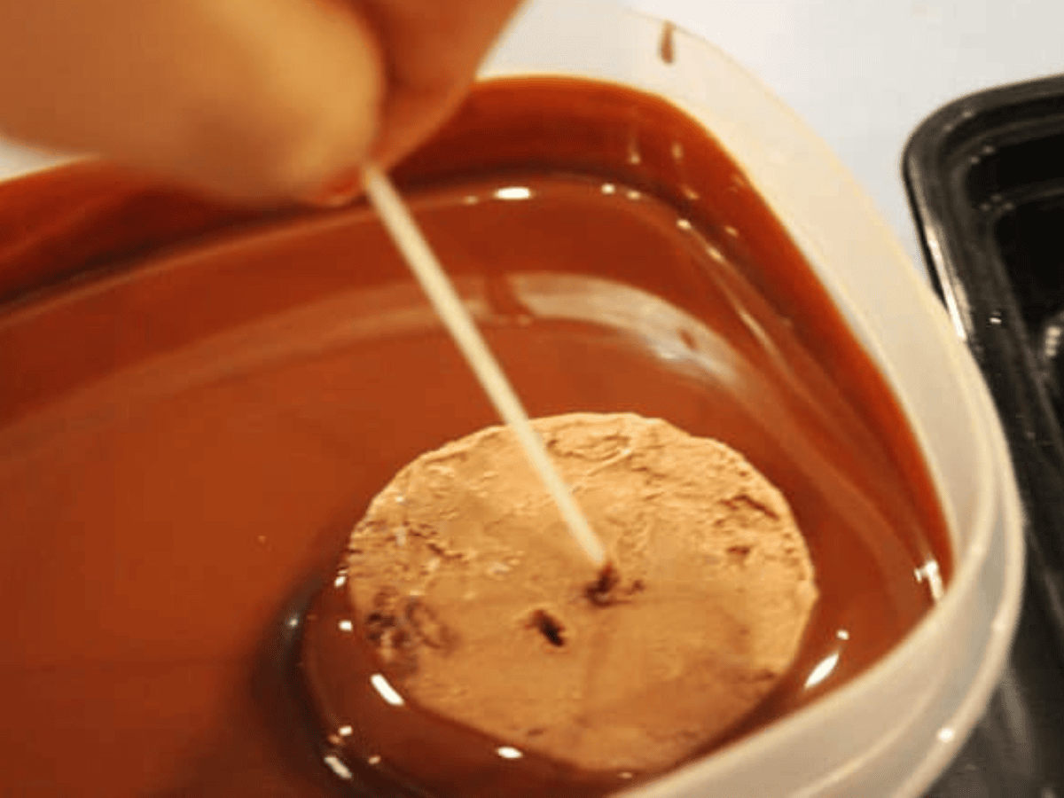 dipping ice cream into chocolate