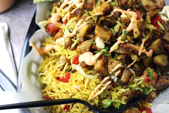 Halal Cart Chicken is boldy spiced and served with fragrant Turmeric Rice and spicy yogurt sauce. The perfect copycat of NY cart food.