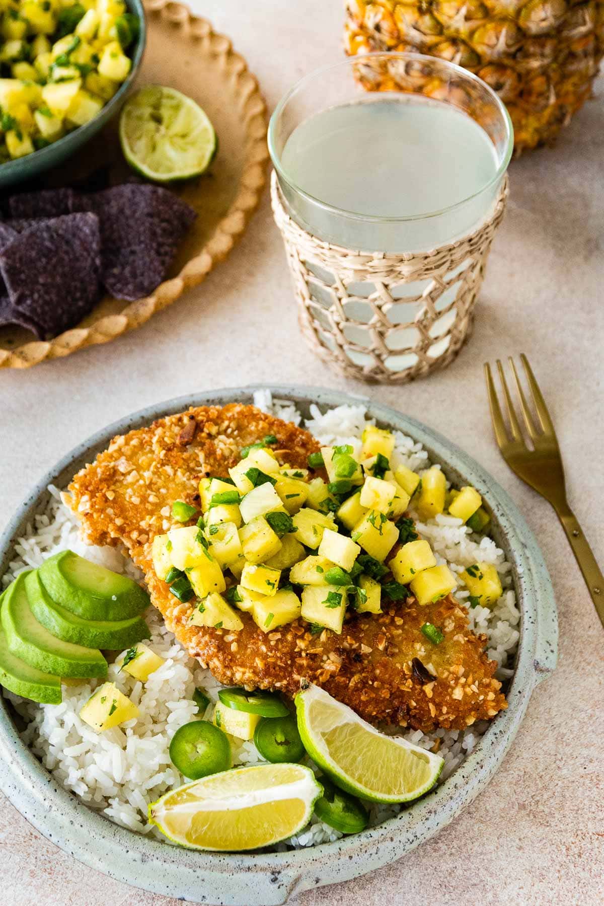Macadamia Crusted Chicken with Pineapple Jalapeno Salsa in bowl with rice and avocado