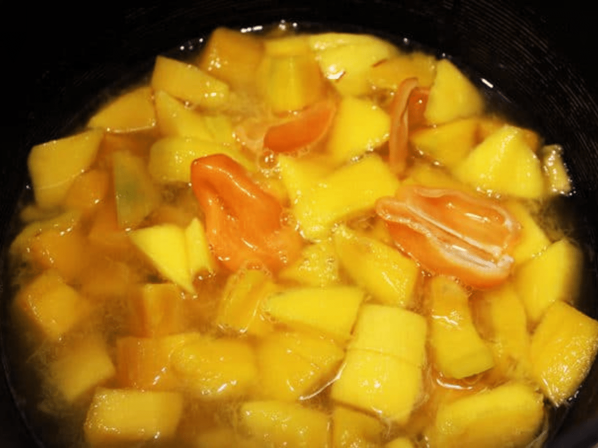 mangos in a pot with habaneros