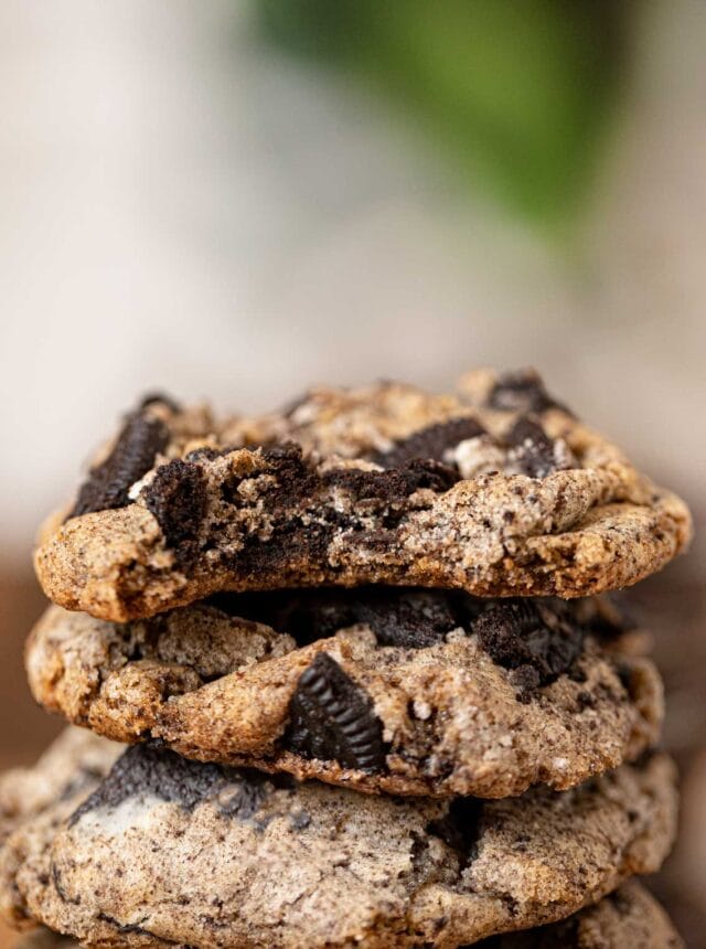Oreo Chunk Cookies in stack with bite removed