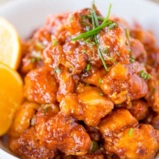 Orange chicken in a bowl with green onions