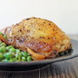Crispy skinned chicken in a luscious white wine sauce with caramelized garlic and green peas. This is a one pot stove-top meal your family is going to absolutely love!