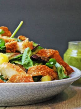 Tropical Macadamia Crusted Chicken on a salad with a Pineapple Jalapeno Vinaigrette and Crispy Wontons. A light summer meal, reminiscent of salads you may eat on a tropical vacation!