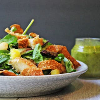 Tropical Macadamia Crusted Chicken on a salad with a Pineapple Jalapeno Vinaigrette and Crispy Wontons. A light summer meal, reminiscent of salads you may eat on a tropical vacation!
