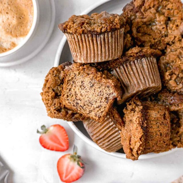Banana Crumb Muffins in serving bowl with one cut in half