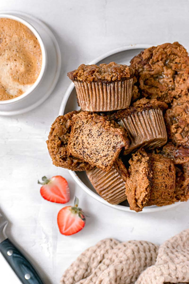 Banana Crumb Muffins in serving bowl with one cut in half