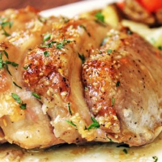 Sliced roasted pork served on a cutting board.