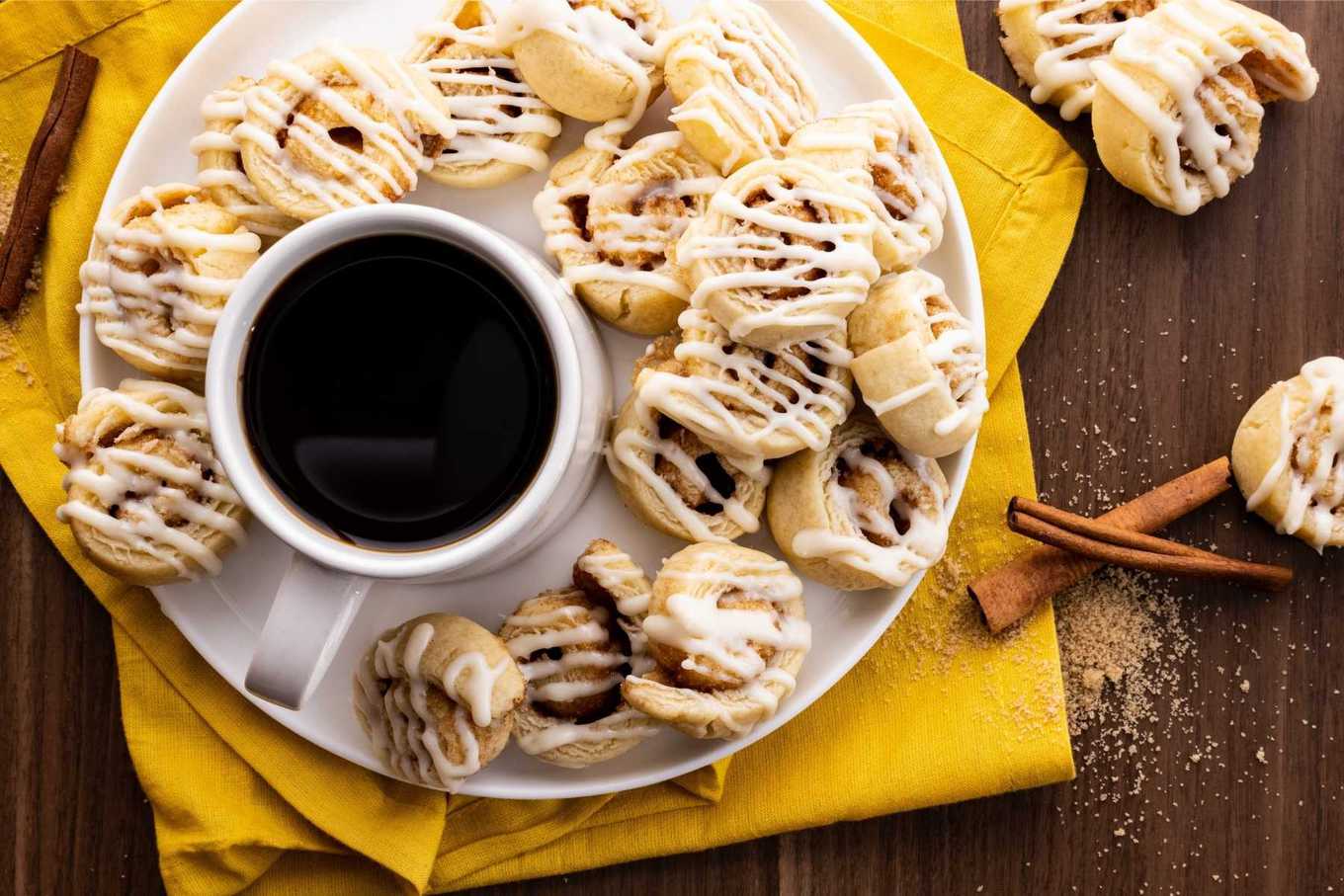 Cinnamon Roll Sugar Cookies on plate with coffee cup
