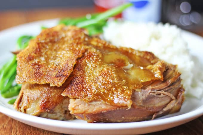 A foolproof EASY slow cooker and oven method for a shatteringly crisp Pork picnic shoulder that is pull apart tender on the inside with a thin crisp cracklin' skin layer.