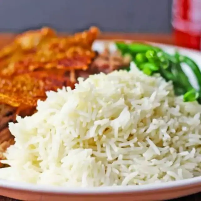 Rice with meat and veggies in the backgroung