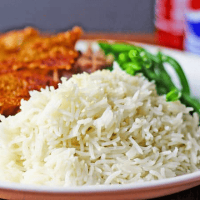 Prepared rice plated with pork and green beans