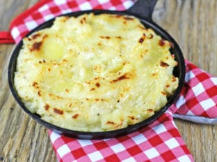 The richest mashed potatoes with five kinds of dairy! They are tangy, cheesy, rich and creamy with a deliciousy crisp crust out of the oven.