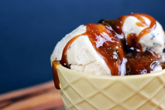 Ice cream scooped into a bowl with caramel topping