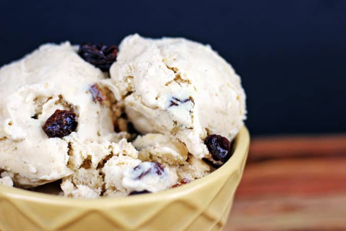 homemade ice cream scooped into a bowl with raisins