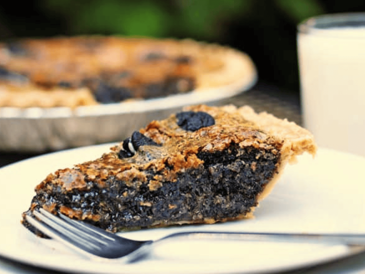 Pie on white plate with fork close by