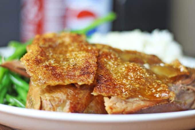 A foolproof EASY slow cooker and oven method for a shatteringly crisp Pork picnic shoulder that is pull apart tender on the inside with a thin crisp cracklin' skin layer.