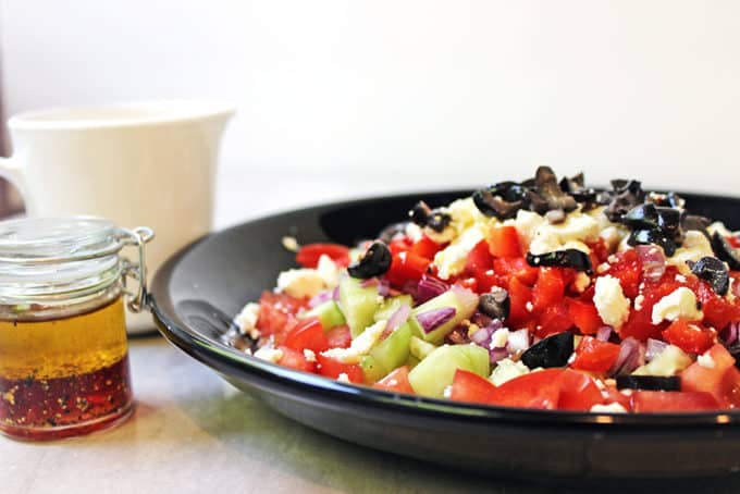 A delicious Greek Vegetable salad in a rainbow of colors. Fresh and healthy it is topped with salty rich feta and kalamata olives. Less than 200 calories a serving, eat the rainbow!
